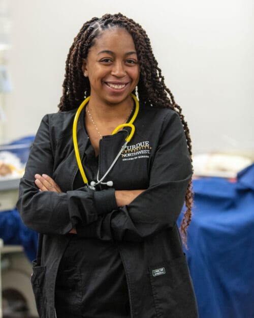 A PNW nursing student wearing a stethoscope in an exam room.