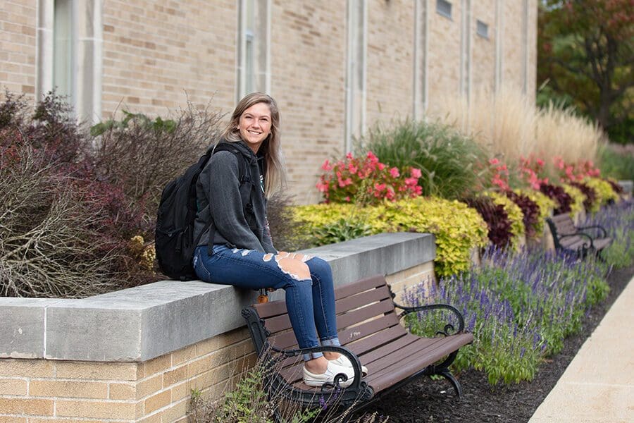 A student sits outdoors on PNW's Westville campus