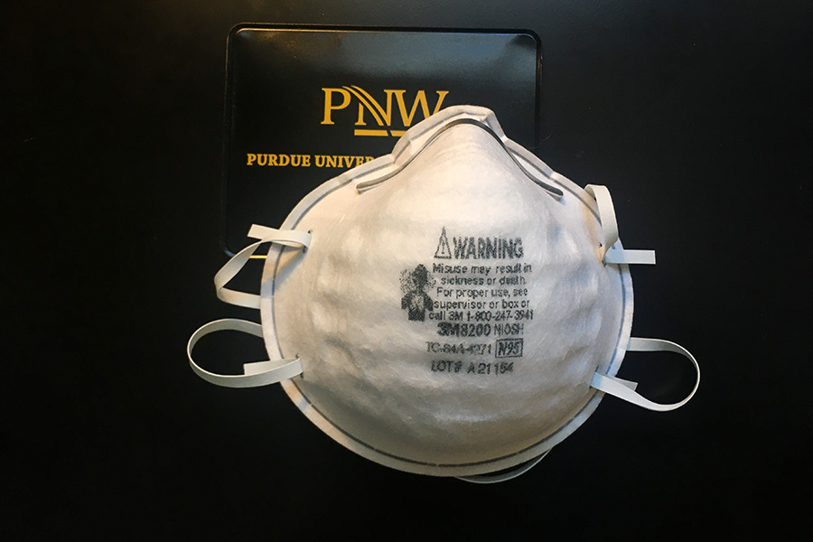 An N95 mask next to a PNW logo