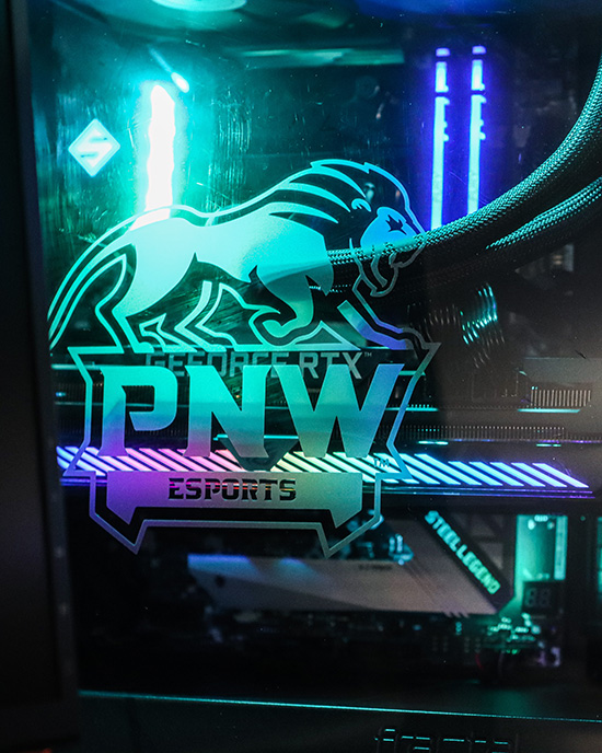 An illuminated computer with a PNW esports logo.