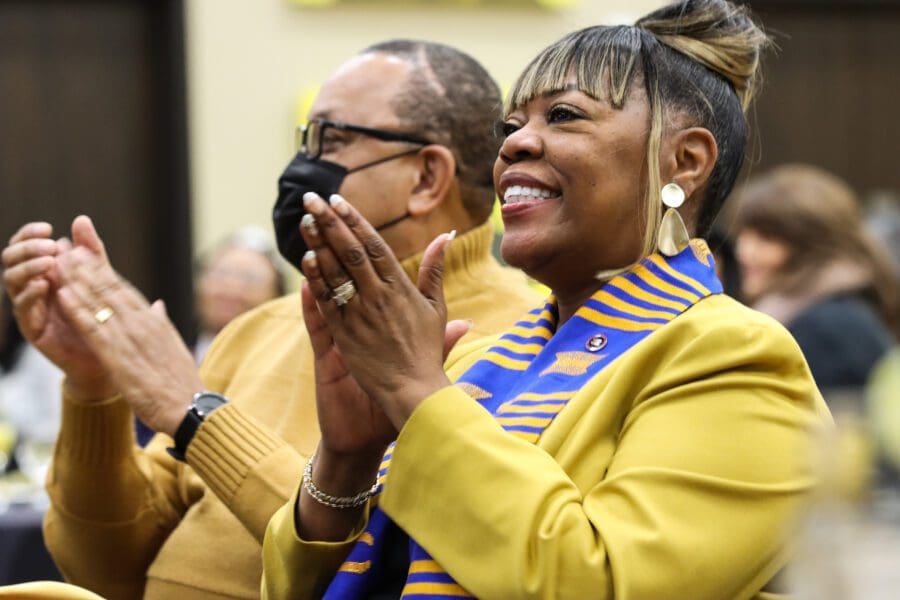 Vanessa Allen-McCloud, applauds during speech