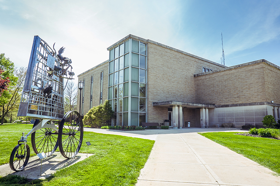 A sculpture in front of a Westville education building