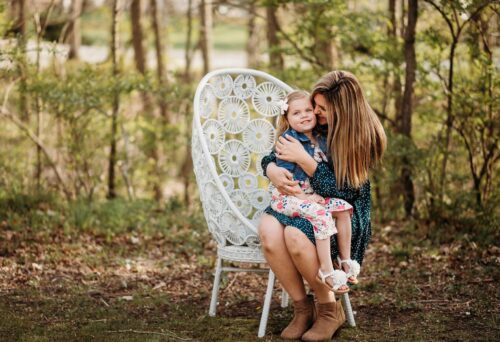 A mom and daughter pose outdoors