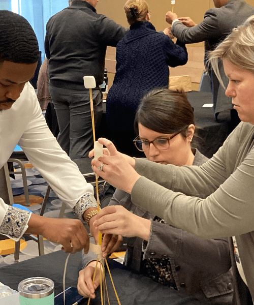 Leadership Northwest Indiana participants engage in a hands-on teamwork exercise during a recent session.