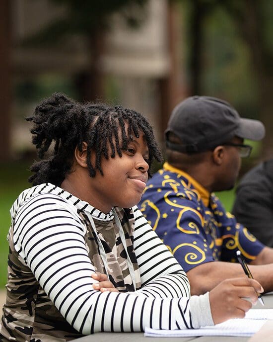 PNW students talk at a picnic table