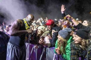 Students cheering and reaching over barricade taking photos with DJ Diesel (AKA Shaquille O'Neal)