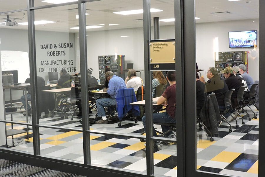 Group of people meeting in the David & Susan Roberts Manufacturing Excellence Center