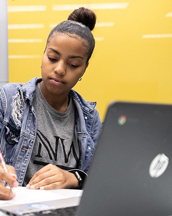 A student works at a table.