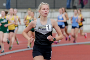 Female student athlete running on track