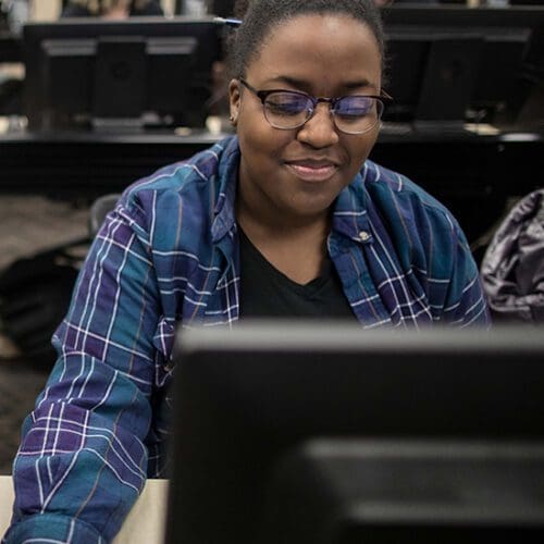 PNW Student working at a computer