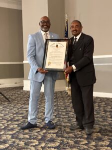 Shontrai Irving and Indiana State Representative Vernon Smith hold Irving's Sagamore of the Wabash award