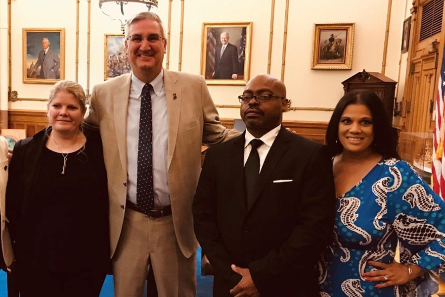 Exonoree Kristine Bunch, Gov. Eric Holcomb, Exoneree Roosevelt Glenn and Nicky Jackson pose together