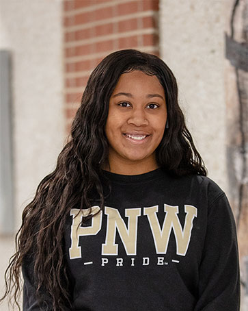 An undergraduate student in a PNW pride shirt