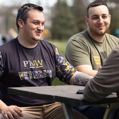 Two PNW veterans sit at a table