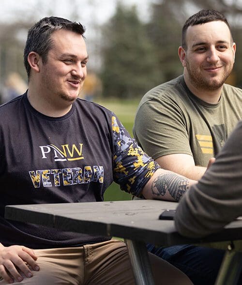 Two PNW veterans sit at a table