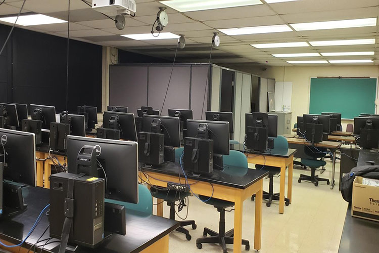 A classroom building with computers and a blackboard