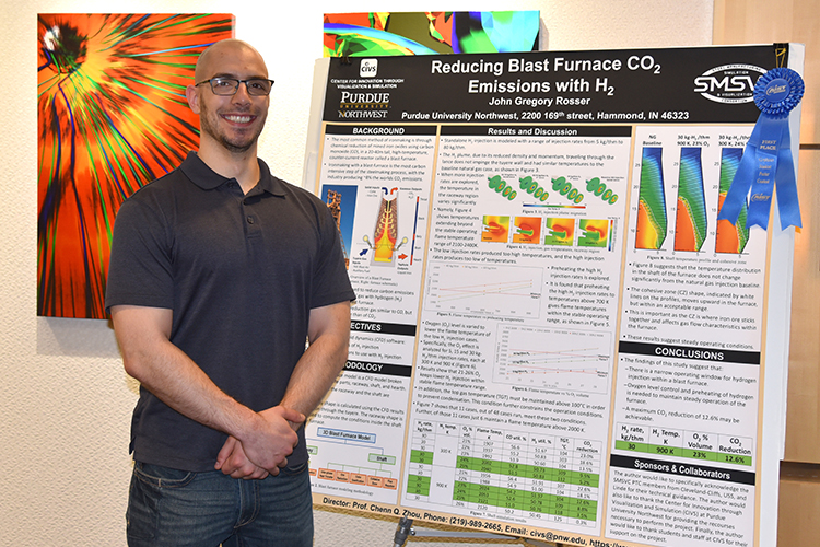 John Rosser stands next to his presentation board