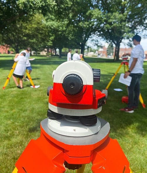 Campers operating surveying equipment