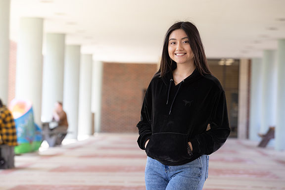 Student stands outdoors