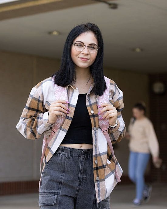 A PNW student stands outdoors