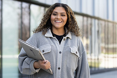 A PNW student stands outdoors