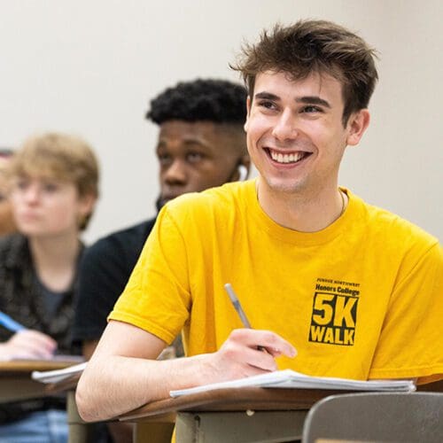 Students sit in desks during a class