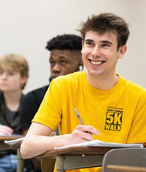 Students sit in desks during a class