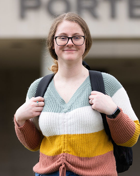 A PNW student stands outdoors.