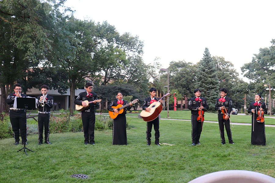 A mariachi band performs on a lawn