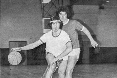 Two students play basketball