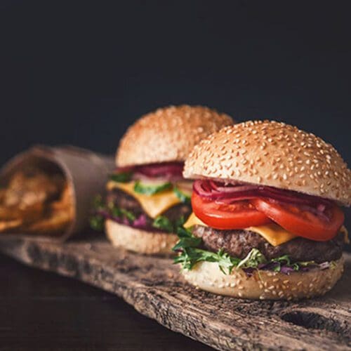 Mini burgers on a wooden serving board