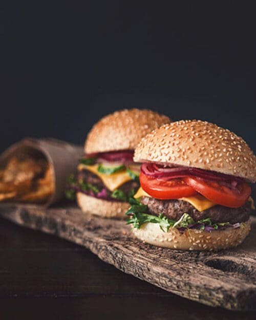 Mini burgers on a wooden serving board