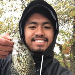 Student poses with a fish