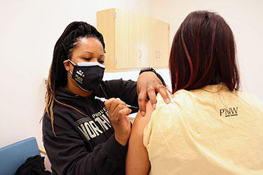 A person receives a COVID vaccine at Purdue University Northwest