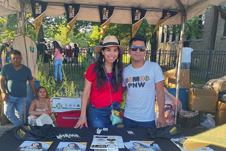Iris Sanchez poses with someone in a Somos PNW t-shirt