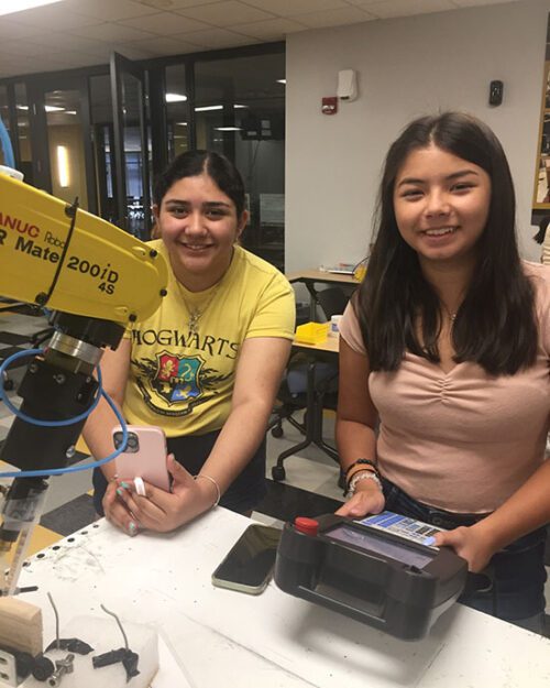 Students work with equipment at a PNW robotics camp