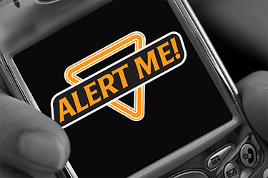 A phone with the "Alert Me" logo on the screen