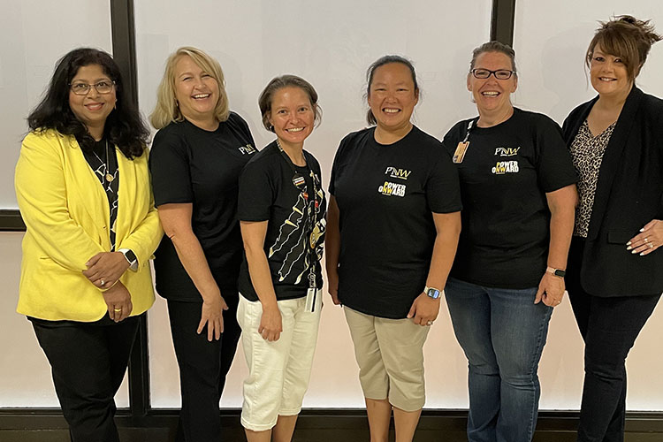 A group of people stand together. Left to right: Neeti Parashar, Angela Schooley, Emily Hixon, Manisa Baker, Christina Nevill, and Debbie Bachmann