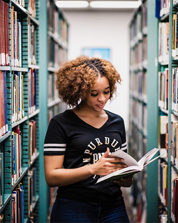 Image of student in library.