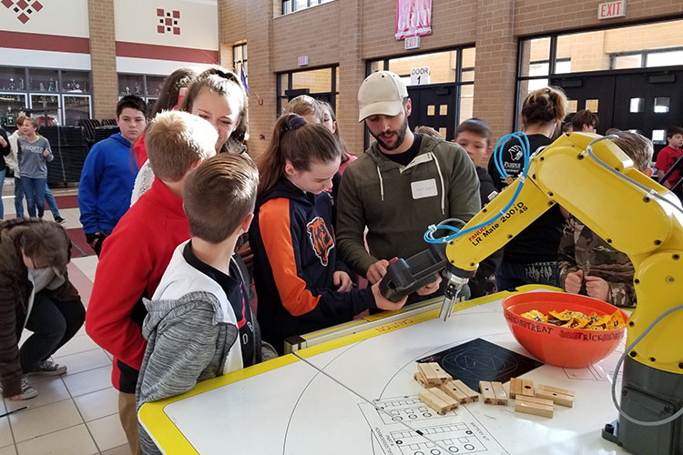 Stem students reviewing a project are pictured.