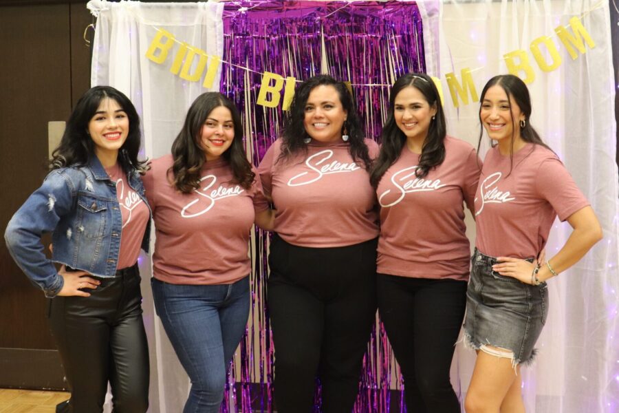 Five women stand together in matching pink shirts that read "Selenas"
