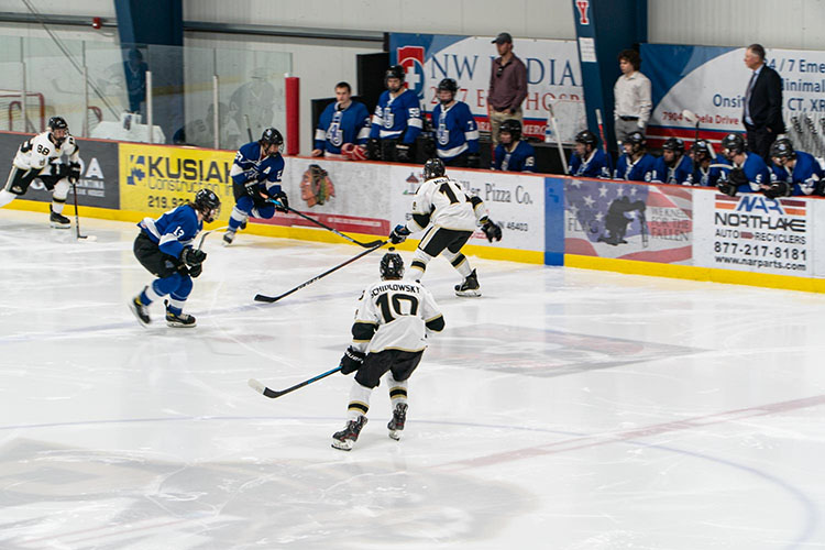 Players chase after the puck during a hockey game