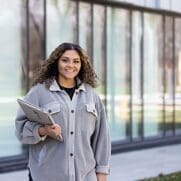 A technology student poses outdoors