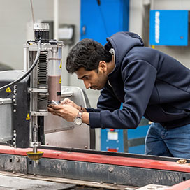 A technology student works in the design studio