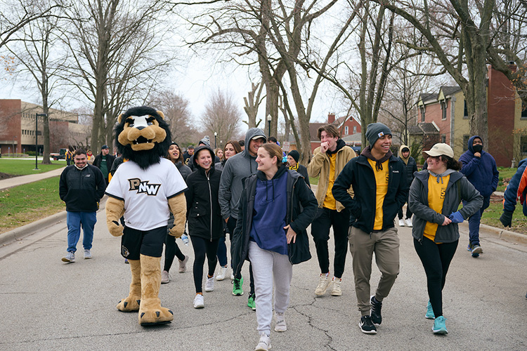 Students walk with Leo during the Honors College 5K