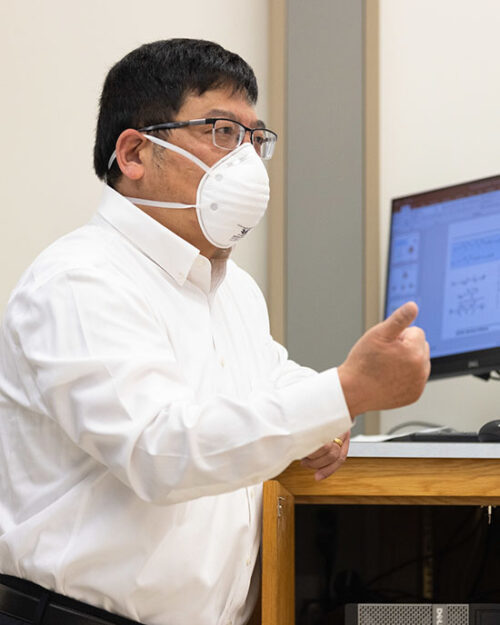 A PNW professor wearing a mask in the classroom.