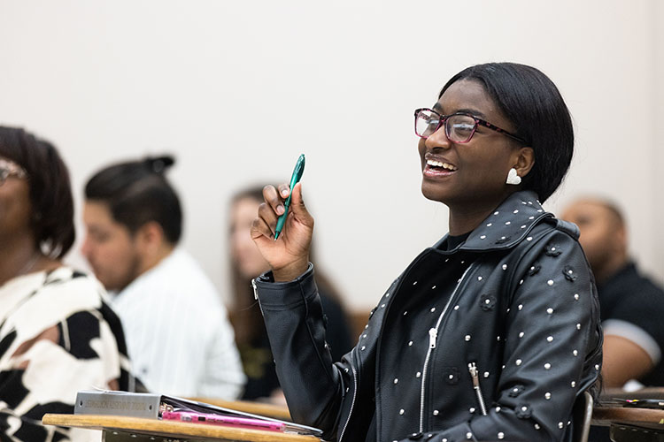 A PNW student laughs in the classroom