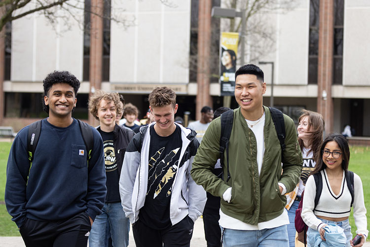 Several students walk together outdoors