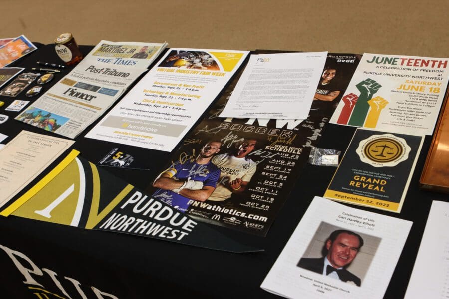 Various departments at PNW contributed numerous items to the new time capsule. Some selections included a university pennant, a signed soccer poster, an event flyer for a Juneteenth celebration, and Career Center event information. Contributed items reflected the 2020-22 time period.