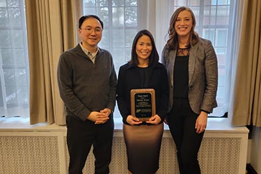 Left to right: Kwangsoo Park, Pitparnee Stompor, and Christina Wright pose together. Pitparnee is holding a 2025 Purdue Focus Award.